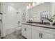 Modern bathroom with dual sinks, a tub, and patterned floor at 5216 Mint Harbor Way # 0284, Charlotte, NC 28269