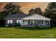 Brick ranch house with a large covered porch at 3021 Davis Park Rd, Gastonia, NC 28052