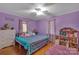 Spacious bedroom with purple walls and teal bedding at 700 Wood St, Troy, NC 27371