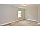 Well-lit bedroom with neutral wall and carpet flooring at 924 Marshville Olive Branch Rd, Marshville, NC 28103