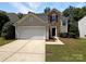 Two-story house with stone accents, a double garage, and a landscaped yard at 1920 Waters Trail Dr, Charlotte, NC 28216