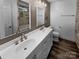 Elegant bathroom with double vanity, marble tile, and soaking tub at 1920 Waters Trail Dr, Charlotte, NC 28216