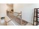 Upstairs hallway with a carpeted staircase and bookshelf at 625 Latrobe Dr, Iron Station, NC 28080