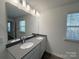 Double vanity bathroom with large mirror at 12312 Riceland Way, Midland, NC 28107