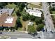 Aerial view showing house surrounded by trees, near a major intersection at 110 Sims Pkwy, Harrisburg, NC 28075