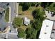 Aerial view of a house surrounded by lush trees, near roads and businesses at 110 Sims Pkwy, Harrisburg, NC 28075