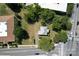 Aerial view showing a house nestled in a lot near roads and buildings at 110 Sims Pkwy, Harrisburg, NC 28075