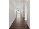 Long hallway with dark hardwood floors and white walls at 526 Mountain View Dr, Monroe, NC 28110