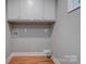 Laundry room with white cabinets and wood floors at 607 Ligon St, Shelby, NC 28150