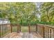 Wooden deck overlooking a fenced backyard and trees at 1405 W Rankin Ave, Gastonia, NC 28052