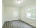 Well-lit bedroom featuring two windows and wood-look flooring at 1405 W Rankin Ave, Gastonia, NC 28052