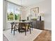 Elegant dining room with a round table, statement art and hardwood floors at 97 Seven Oaks Lndg, Belmont, NC 28012