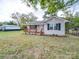 Newly constructed home with gray vinyl siding, wooden porch, and detached shed at 203 Peyton St, Chester, SC 29706