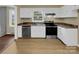 Kitchen with white cabinets, stainless steel appliances, and hardwood floors at 1525 Vanderlip Dr, Gastonia, NC 28052