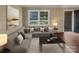 Living room with L-shaped sofa, coffee table, and hardwood floors at 1525 Vanderlip Dr, Gastonia, NC 28052
