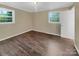 Bright bedroom with wood-look floors and two large windows at 1525 Vanderlip Dr, Gastonia, NC 28052