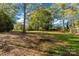 Large backyard with mature trees providing shade and a serene atmosphere at 412 E Jefferson St, York, SC 29745