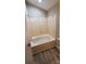 A clean bathroom with an oval tub and laminate walls at 5720 Ebley Ln, Charlotte, NC 28227