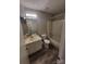 Bathroom with single sink vanity, bathtub, and updated flooring at 5720 Ebley Ln, Charlotte, NC 28227