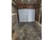 Attached garage with white door and concrete flooring at 5720 Ebley Ln, Charlotte, NC 28227