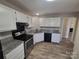 Modern kitchen featuring granite countertops, stainless steel appliances, and white cabinets at 5720 Ebley Ln, Charlotte, NC 28227