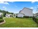 Large backyard with a black fence and green grass at 305 Redberry Ct, York, SC 29745