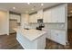 Modern kitchen with white cabinets and a large island at 1536 Harper Landing Blvd, Stanley, NC 28164