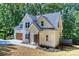 Two-story home with a white exterior and a wooden garage door at 159 Scotch Irish Ln, Troutman, NC 28166