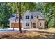 Two-story home with a white exterior and a wooden garage door at 159 Scotch Irish Ln, Troutman, NC 28166