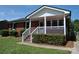 Brick ranch home with covered porch and landscaped yard at 500 Doffin Ln, Gastonia, NC 28052