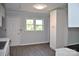 Eat-in kitchen with white cabinets and wood-look floors at 500 Doffin Ln, Gastonia, NC 28052