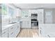 Modern kitchen with white cabinets, stainless steel appliances, and light floors at 335 Davidson Hwy, Concord, NC 28027