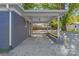 Covered carport with a gravel driveway and flower bed at 335 Davidson Hwy, Concord, NC 28027