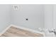 Small laundry room with hookups and light gray walls at 335 Davidson Hwy, Concord, NC 28027