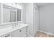 Modern bathroom with white vanity, quartz countertop and a large mirror at 335 Davidson Hwy, Concord, NC 28027
