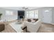 Living room with fireplace, large windows, and neutral decor at 335 Davidson Hwy, Concord, NC 28027