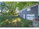 Detached gray garage with a large door in the backyard at 335 Davidson Hwy, Concord, NC 28027