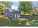 Detached gray garage with a large door and steps leading up to it at 335 Davidson Hwy, Concord, NC 28027