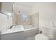 Bathroom with a bathtub, shower, and updated vanity at 225 Flint St, Charlotte, NC 28216