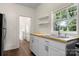 White kitchen cabinets, wood countertops, and a farmhouse sink at 225 Flint St, Charlotte, NC 28216