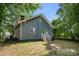 Gray house exterior with green door and side yard at 225 Flint St, Charlotte, NC 28216