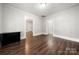 Living room with hardwood floors and multiple entries to other rooms at 225 Flint St, Charlotte, NC 28216