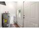 Laundry area with water heater and exterior access at 225 Flint St, Charlotte, NC 28216