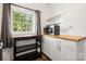 Kitchen corner with wood countertops and white cabinets at 225 Flint St, Charlotte, NC 28216