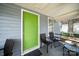 Front porch with green door and seating area at 225 Flint St, Charlotte, NC 28216