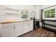 Modern kitchen with white cabinets, wood countertops, and stainless steel appliances at 225 Flint St, Charlotte, NC 28216