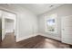 Well-lit bedroom featuring hardwood floors and a window at 225 Flint St, Charlotte, NC 28216