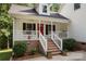 Inviting front porch with red door and rocking chairs at 1447 London Dr, Rock Hill, SC 29732