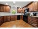 Spacious kitchen with dark wood cabinets, granite countertops, and hardwood floors at 1447 London Dr, Rock Hill, SC 29732
