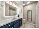 Clean bathroom with navy vanity, tile floors and a large mirror at 1447 London Dr, Rock Hill, SC 29732
